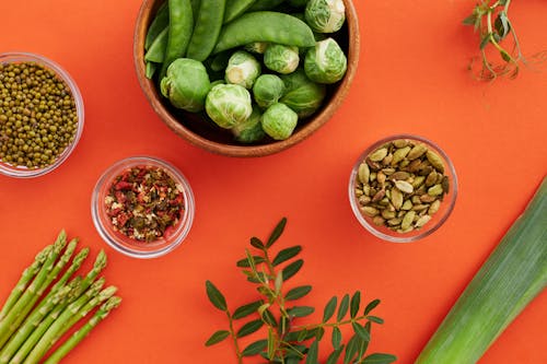 Top View of Vegetables and Seeds Lying on Red Background