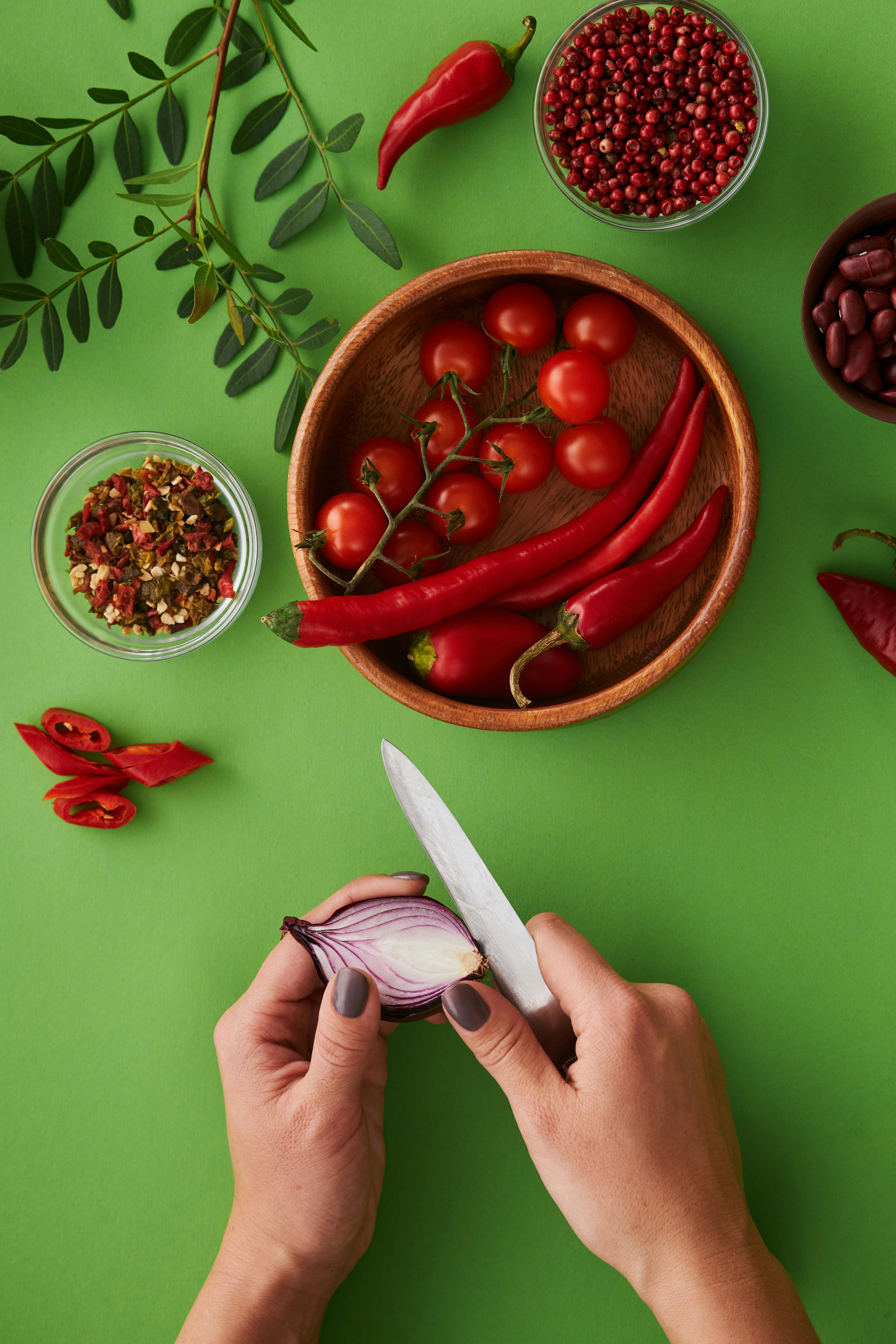 person slicing an onion