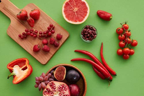 Free Top view of a vibrant selection of fruits and vegetables on a green background. Stock Photo