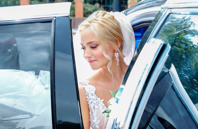 Gorgeous Bride Sitting In Fancy Car