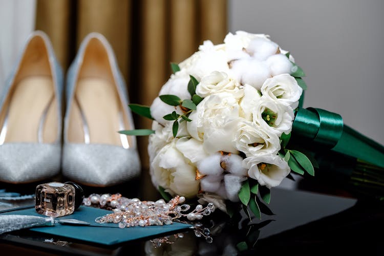 Bridal Shoes And Bouquet On Table