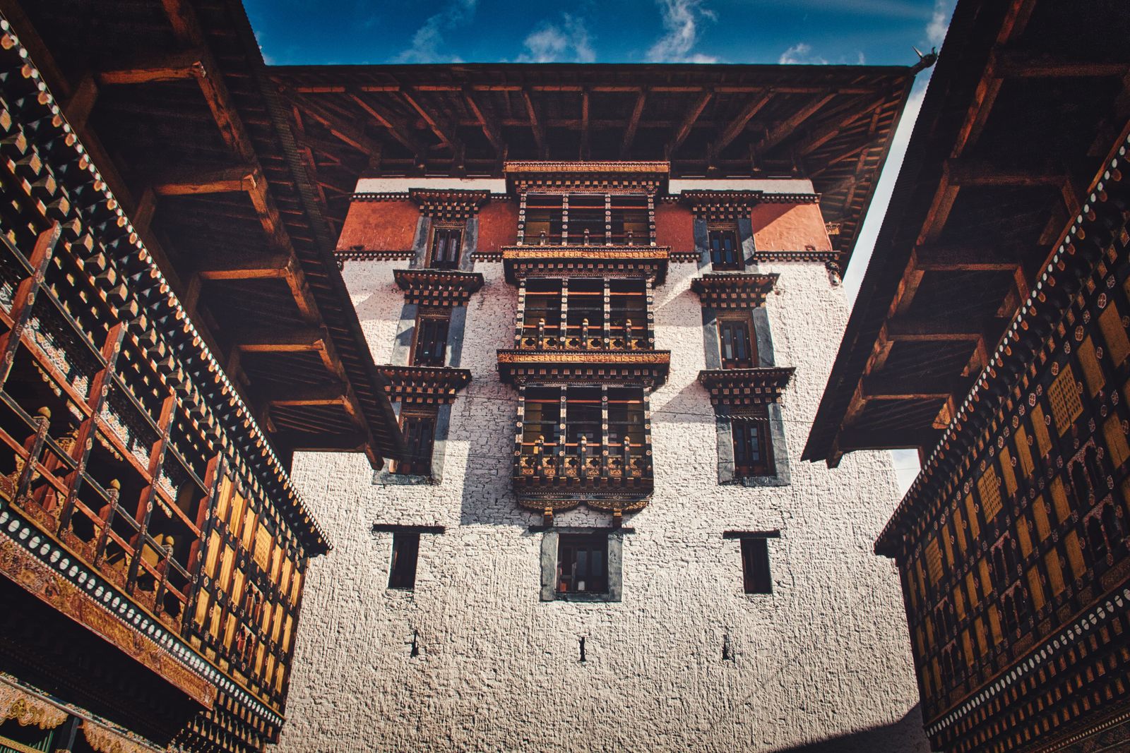 The whitewashed central tower of Rinpung Dzong in Paro framed by dark carved timber galleries