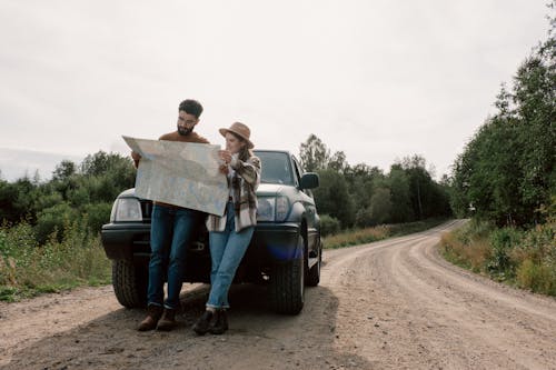 Free A Couple on a Road Trip Looking at a Map  Stock Photo