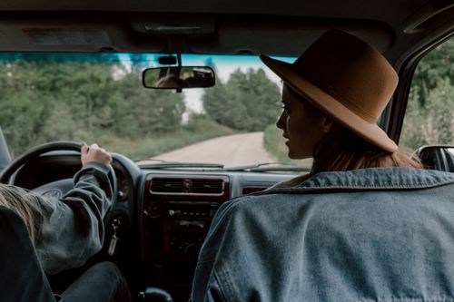 Free Two women on a scenic road trip, captured from inside the car, showcasing a relaxed and adventurous vibe. Stock Photo