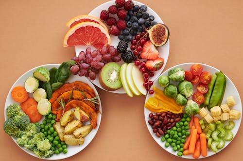 Top View of Plates Full of Fruits and Vegetables 