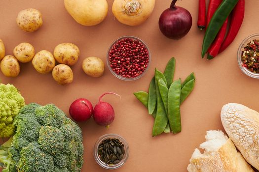 Top view of fresh ingredients including vegetables and bread, ideal for healthy cooking concepts.