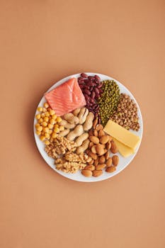 Colorful assortment of proteins and legumes on a white plate, perfect for healthy eating inspiration.