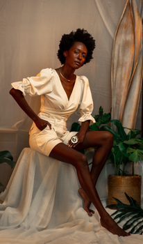 Stylish African woman posing gracefully in a chic outfit, exuding elegance and confidence.