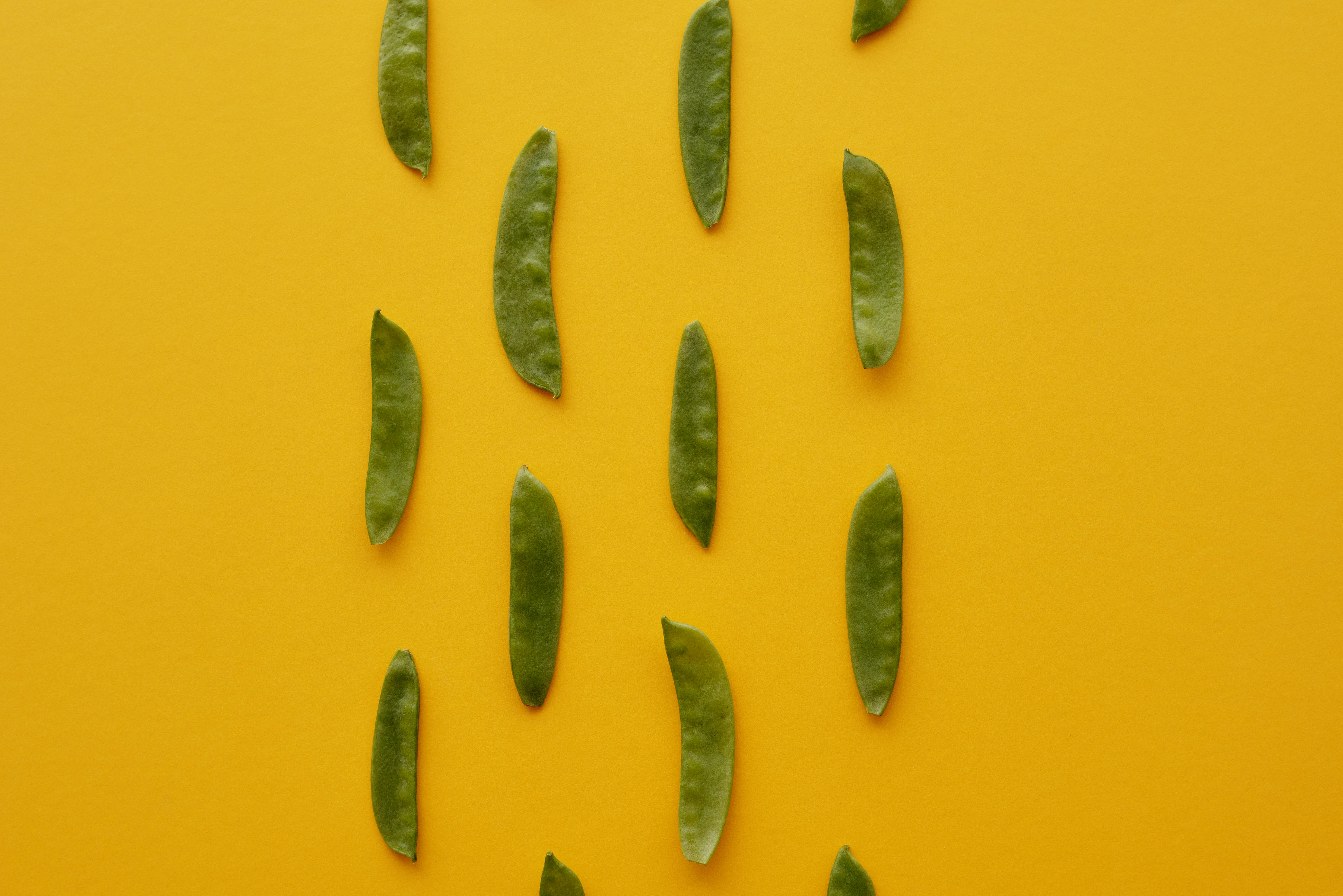 green peas on yellow background