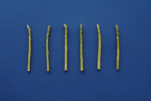 Green Asparagus on Blue Surface