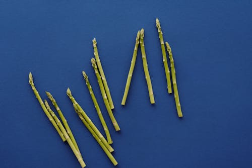 Green  Asparagus on Blue Surface