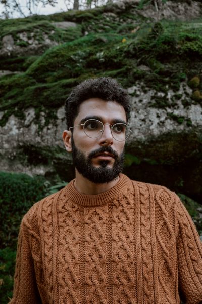 Man in a cable-knit sweater outdoors — photo by cottonbro studio on Pexels