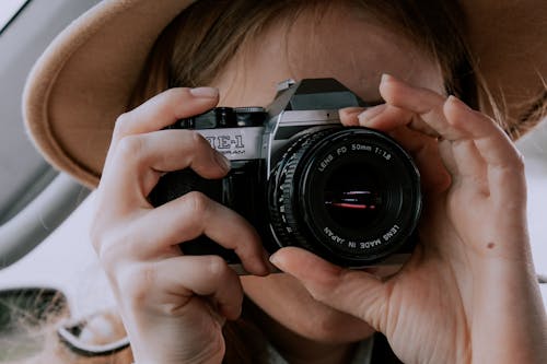 Person Holding Black Camera