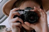 Person Holding Black and Silver Nikon Dslr Camera