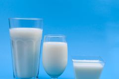 Three types of milk glasses on a blue backdrop, illustrating variety.
