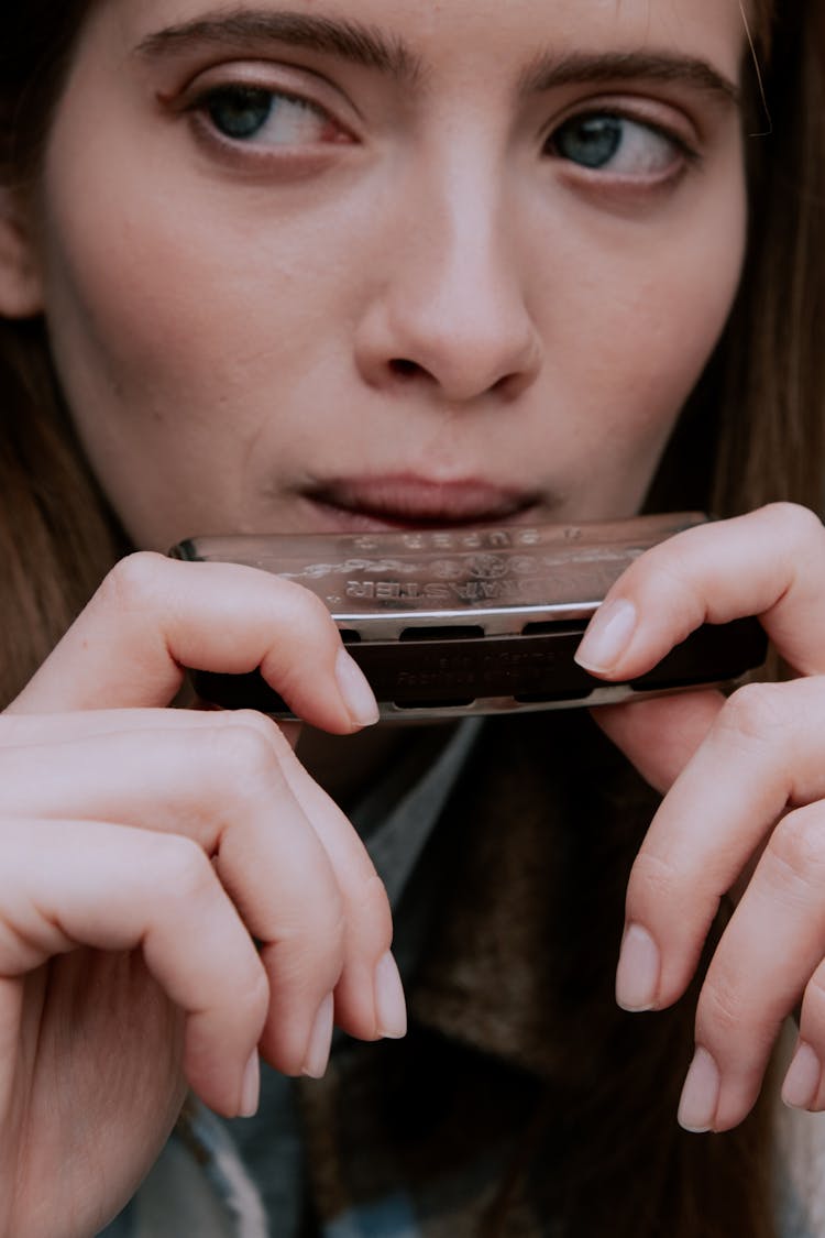 Woman Playing The Harmonica