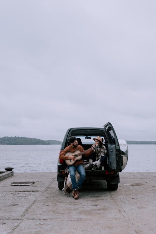 Couple Sitting at the Back of a Car