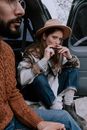 Woman in Fedora Hat Playing Harmonica
