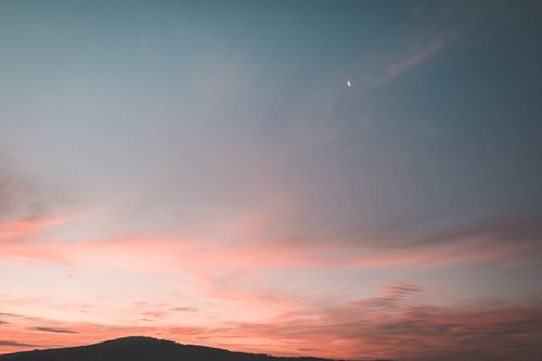 Free Picturesque scenery of sky with bright colors and silhouettes of mountains at sundown Stock Photo