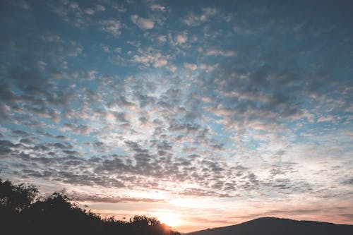 Cloudy sky over mountains and forest