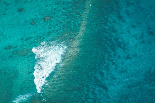 Turquoise water of ocean with foam