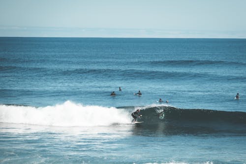 Stormy sea with wavy surface and surfers