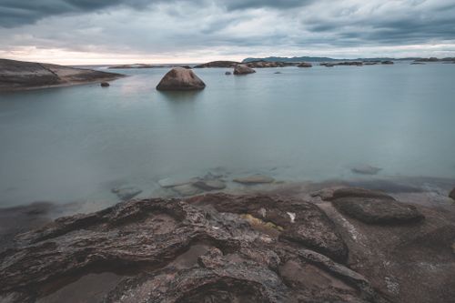 Free Amazing scenery of shallow rocky shore with tranquil seawater under majestic cloudy sky Stock Photo