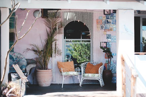 Sunny porch with comfy chairs and potted plants