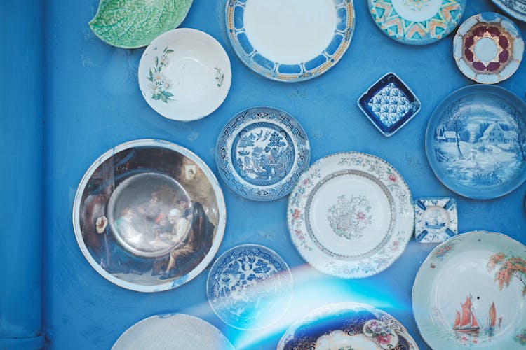 Many Ornamental Plates Decorating Blue Wall