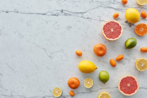 Citrus Fruits on White Surface