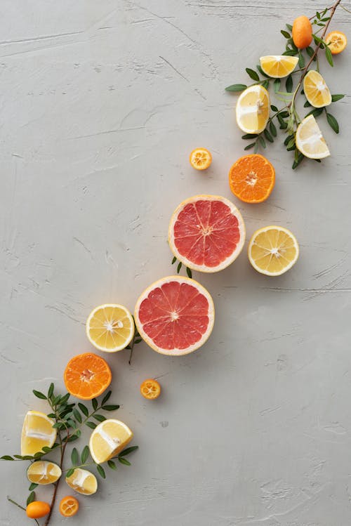 Sliced Citrus Fruits on Gray Surface