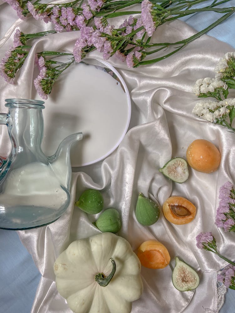 Arrangement Of Glass Pitcher With Fruits On Cloth