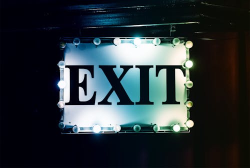 White and Black Lighted Exit Signage