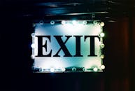 在黑暗的背景下，明亮的出口标志唤起了复古的美感