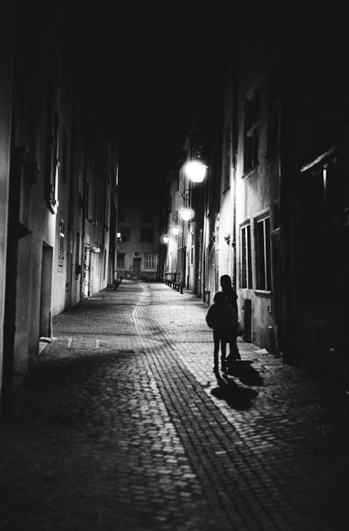 Monochrome Photo People Walking in Alley