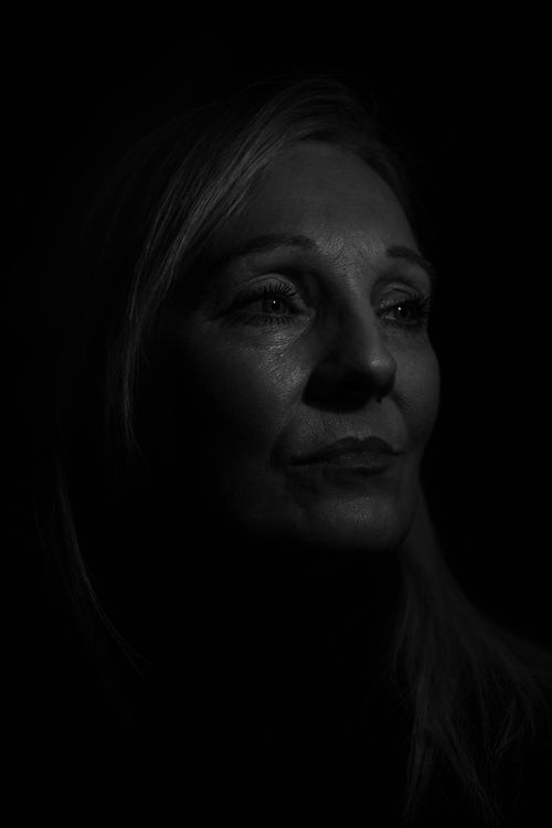 Free A compelling black and white portrait capturing an adult woman's contemplative expression. Stock Photo