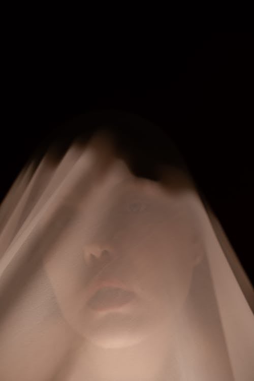 Calm woman under white veil