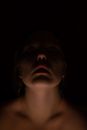 Crop woman standing in darkness