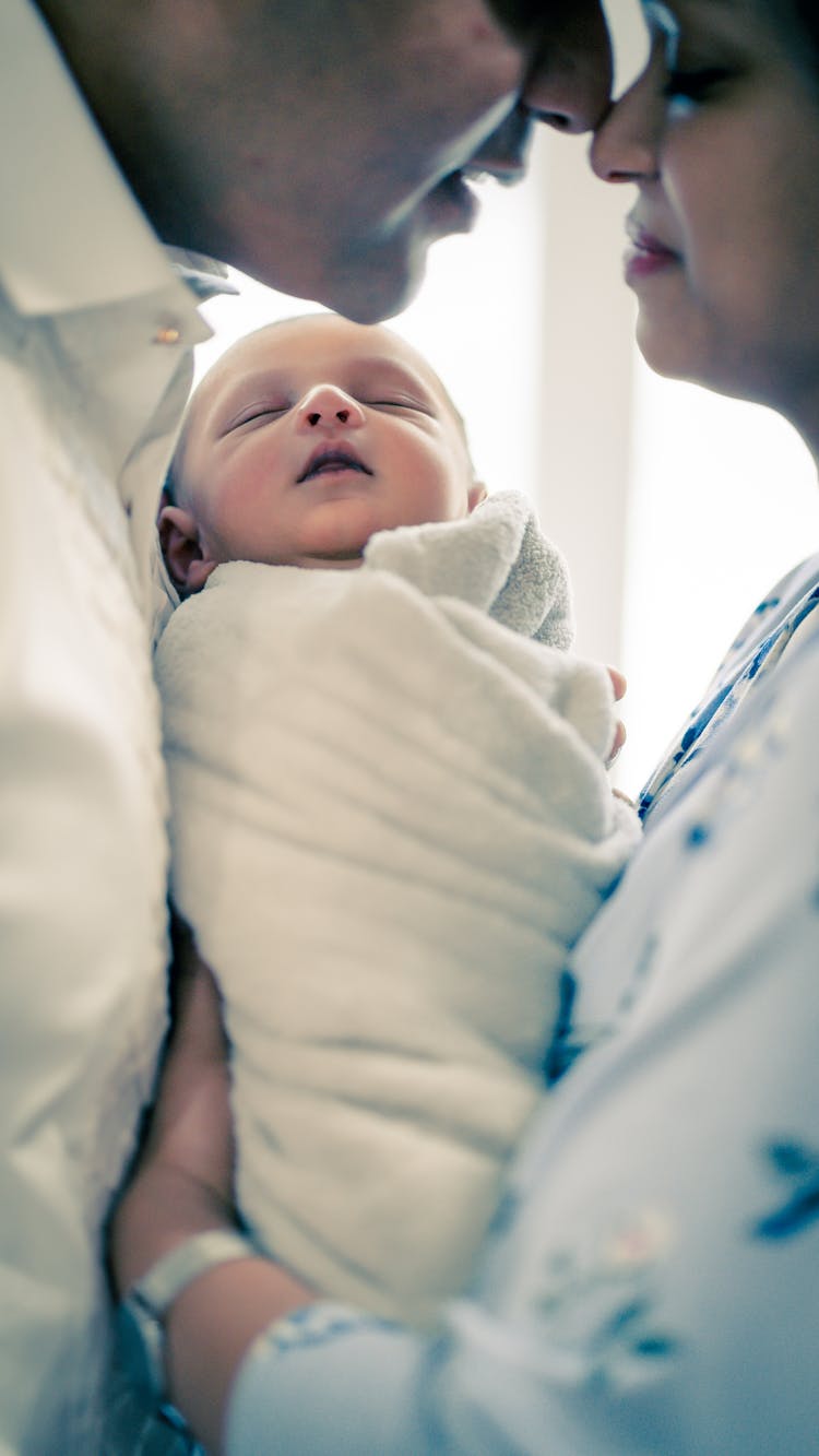 Romantic Couple With Newborn Baby In Daytime