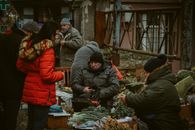 Vendors and shoppers in winter attire at a Chișinău street market.