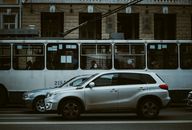 Street view of public transport and cars in downtown Chișinău, capturing daily urban life.