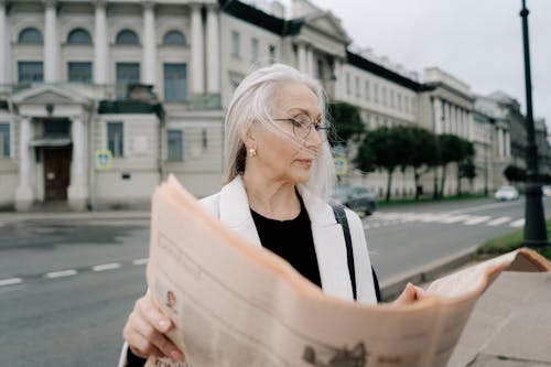 Elderly Woman Reading Newspaper