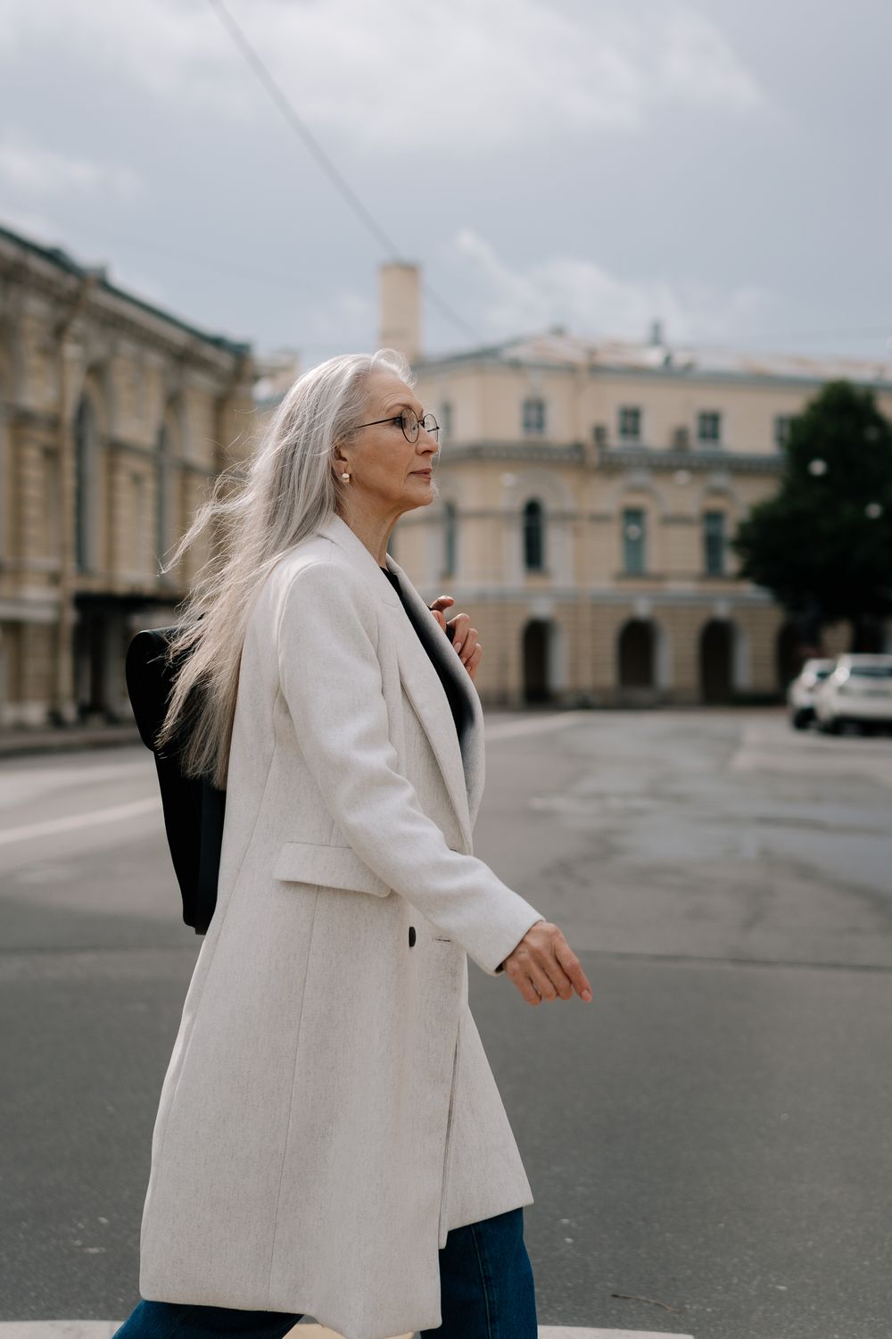 A Woman Wearing a White Coat Walking · Free Stock Photo