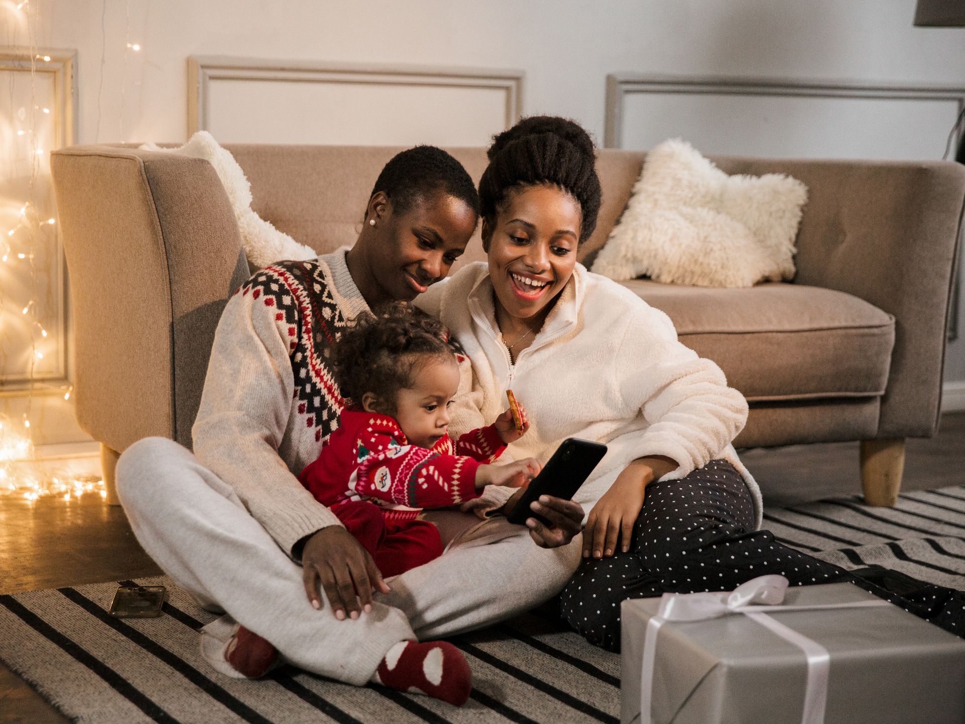 Cheerful family video calling together in cozy living room during Christmas time.