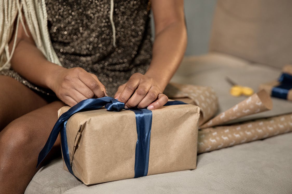 Close-Up Shot of a Person Wrapping a Gift Box