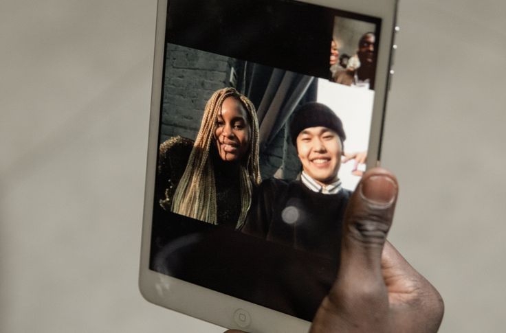 person smiling while using dating app on smartphone