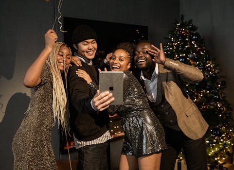Group of young adults enjoying a festive virtual Christmas party, posing for a selfie.