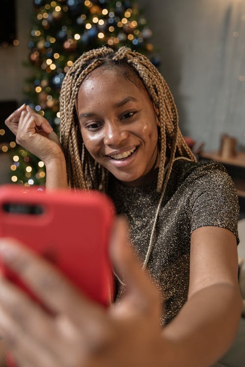 Free Woman Holding Red Smartphone Stock Photo