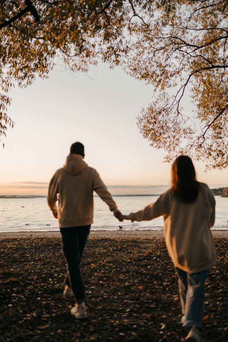 A Couple Walking On The Beach