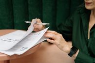 Person in Green Long Sleeve Shirt Holding White Pen